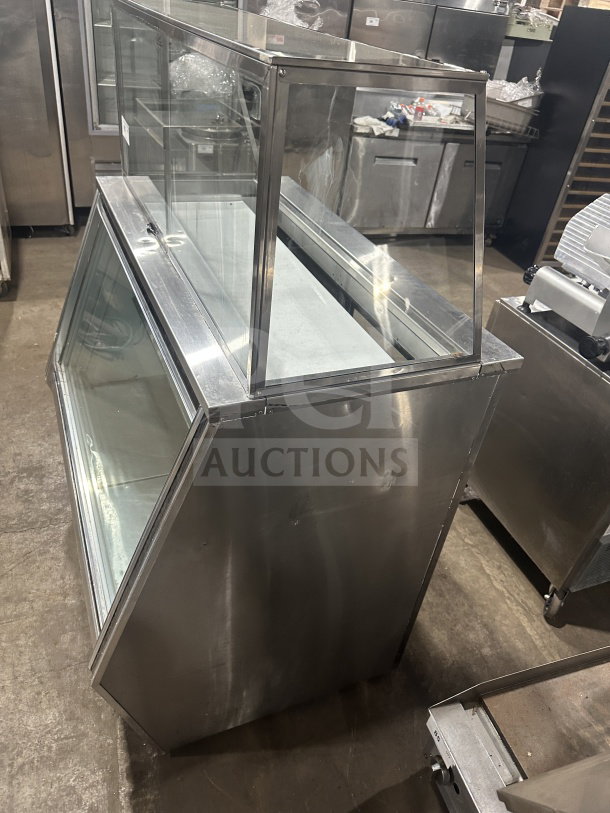 Leader stainless steel dual-service refrigerated deli case with sliding rear glass doors and ambient top counter display.
