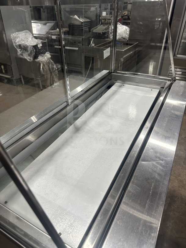 Leader stainless steel refrigerated deli case with sliding rear glass door and ambient top counter. Used condition.