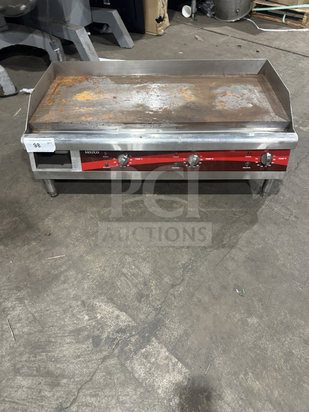 Avantco 36" stainless steel electric griddle, model 177EG36N. Features thermostatic controls, back & side splash, on legs. Visible wear.