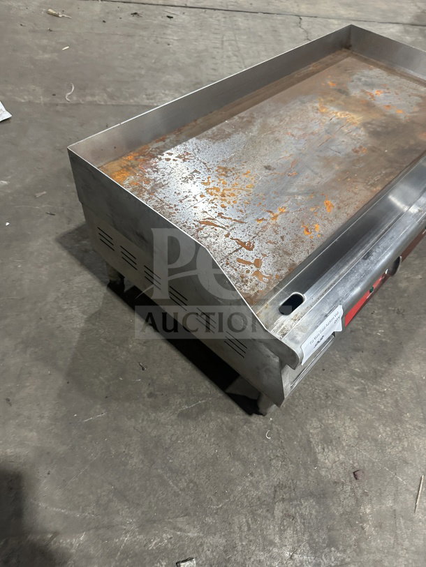 Avantco 36" stainless steel electric griddle, model 177EG36N, with thermostatic controls, back & side splash, on legs. Condition: used.
