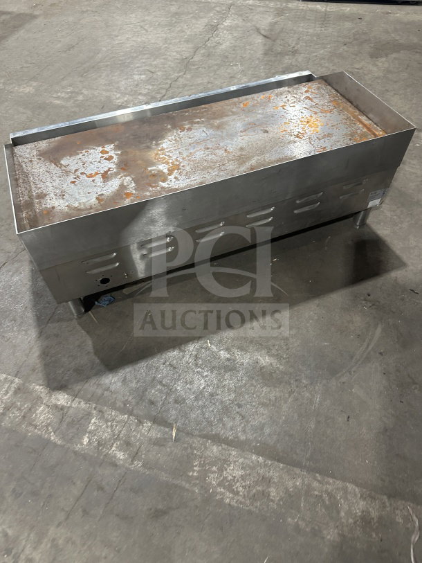 Avantco 36" stainless steel electric flat griddle, model 177EG36N, with thermostatic controls, back and side splash, on legs.