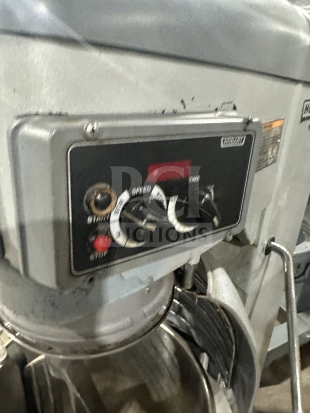 Hobart HL300 commercial mixer with controls, stainless steel bowl guard, and mixing bowl. Includes flat beater attachment.