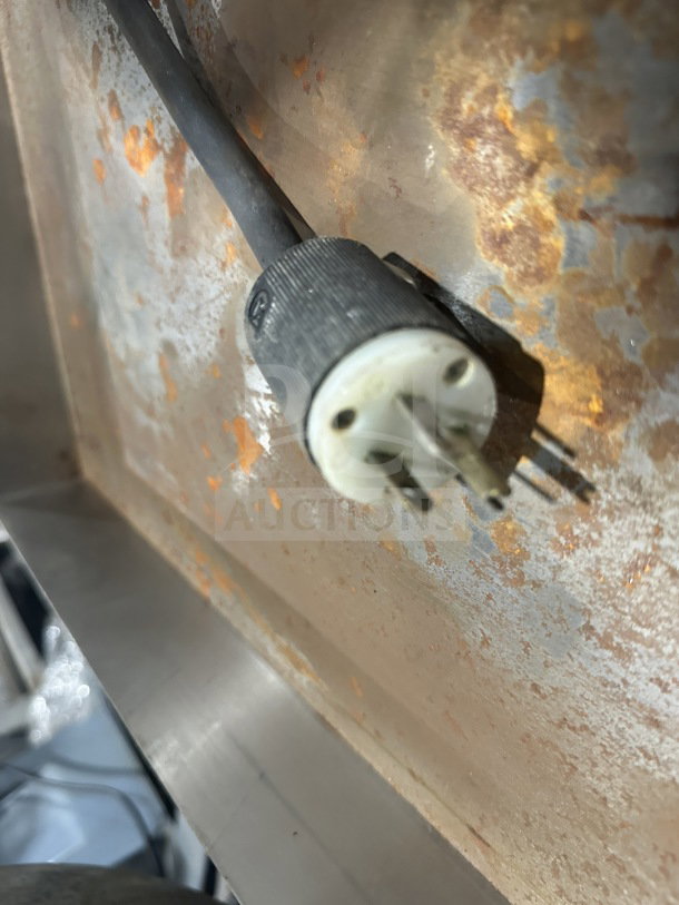 Close-up of a plug from a Hobart HL300 commercial mixer, showing wear and rust on the surrounding metal surface.