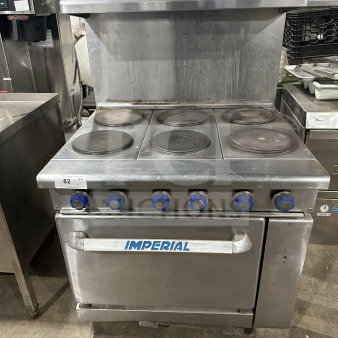 Imperial Commercial Stainless Steel 6-burner electric range/oven combo with backsplash, salamander shelf, and wired oven rack.
