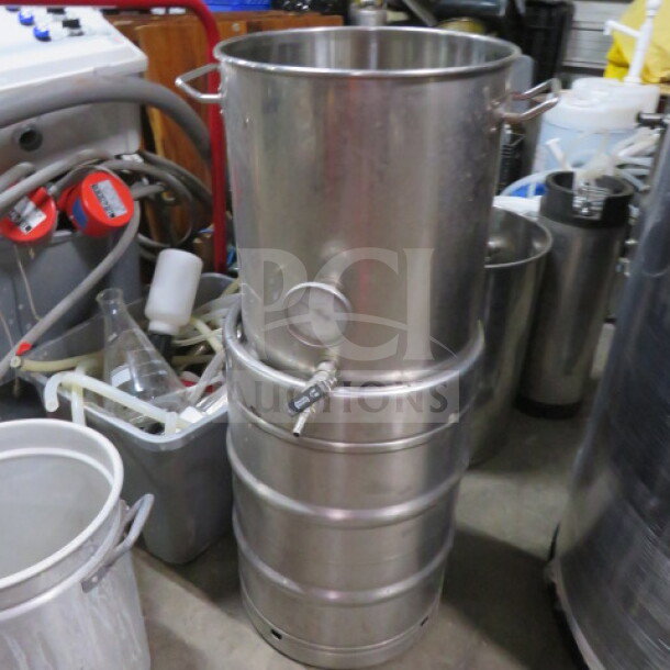 Metal brew kettle from a 3 vessel brewhouse, 253-gallon capacity, visible heat exchanger, spigot, and gauge, good condition.