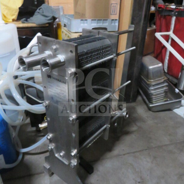 Three-vessel brew house with heat exchanger, 253-gallon capacity, stainless steel construction, industrial setting.