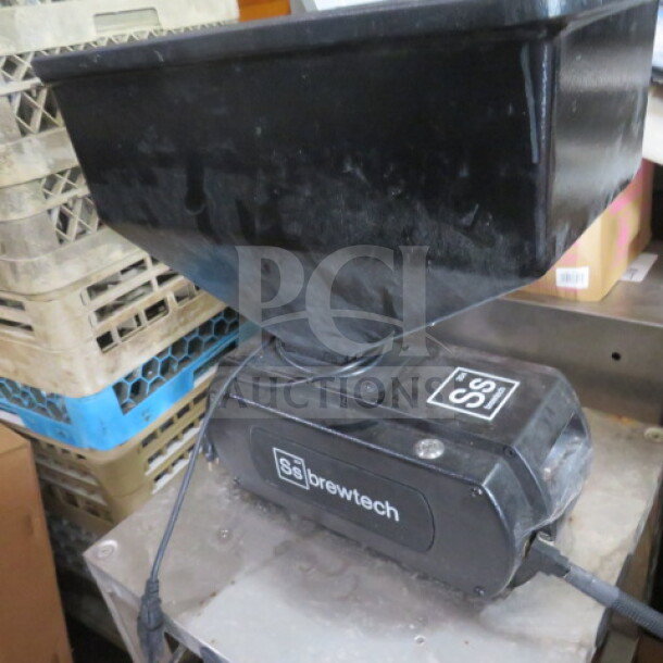 Brewtech SS 304 grain mill on casters, black finish, visible logo and markings, used condition, for brewing grain processing.