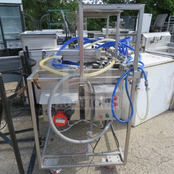One 3 Vessel Brew House with Thermaline Heat Exchanger #T4-S-20, 253 Gallon, featuring controls and hoses, in used condition.