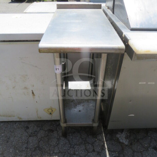 Stainless steel table with under shelf, dimensions 15x30x37 inches. Visible wear, suitable for commercial use.