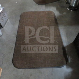Brown rectangular rug, 36x60 inches, with rounded edges. Used condition, subtle woven pattern.