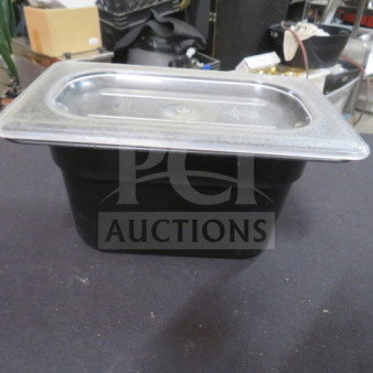 1/9 size 6" deep black food storage container with labeled stainless steel lid, in good condition.