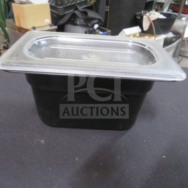 1/9 size 6-inch deep black food storage container with transparent lid, used condition, ideal for kitchen organization.