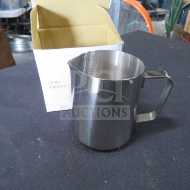 NEW 12oz stainless steel frothing pitcher, pristine condition, shiny finish, with original box labeled "12 Oz Stainless."