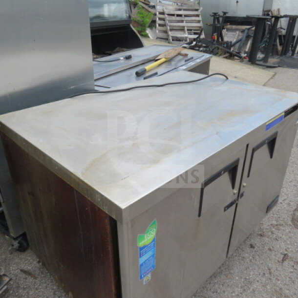 Everest ETBF2 2-door stainless steel worktop freezer on casters, 47.5x31.5x35 inches, 115V, visible wear, model label displayed.