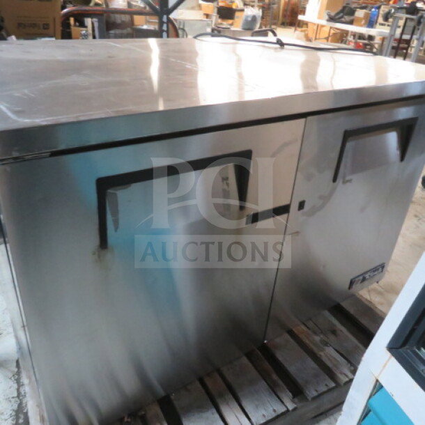 True TUC-48F worktop freezer, stainless steel, two doors, on casters. Dimensions 48x30x34 inches, excellent condition. 115V.