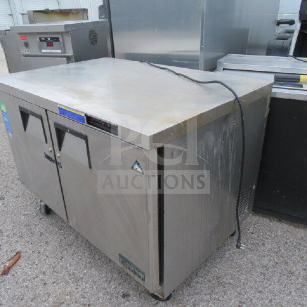 True TUC-48F two-door worktop freezer on casters, 48x30x34 inches, 115 Volt, stainless steel, used condition, visible labels.