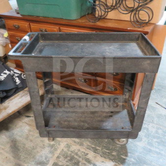 Black poly utility cart with 2 shelves on casters, measures 34x17.5x32.5 inches, slightly worn condition.