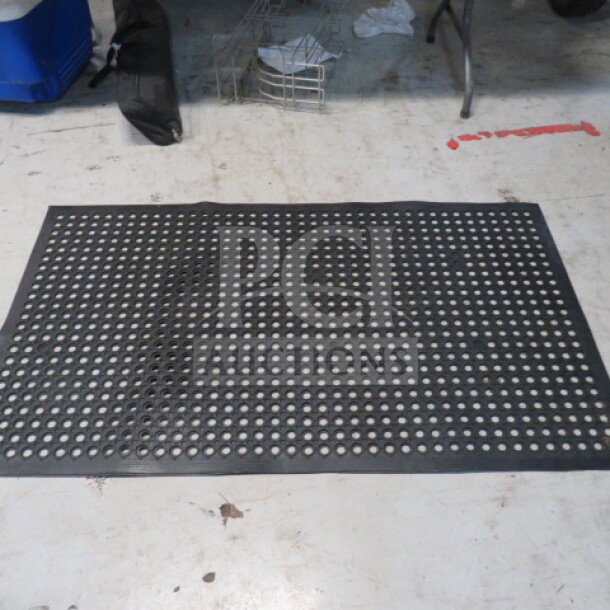 Black 35"x59" fatigue mat with perforated holes, new condition, anti-slip design, ideal for workplace comfort.