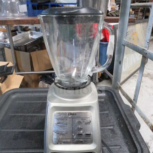 Oster Hi Speed Blender with glass pitcher, silver base, and control panel. Used condition, working order.