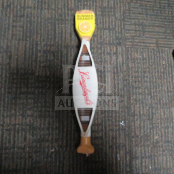 Leinenkugel's Summer Shandy tap handle, yellow top with a lemon graphic, logo in red, excellent condition.