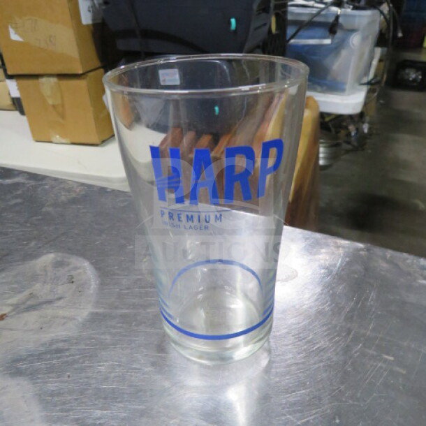 Harp Premium Lager beer glass, clear with blue logo, excellent condition, standard pint size, no visible damage.
