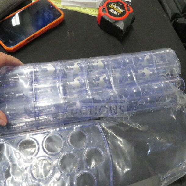 Clear Horeca shot glass holder with 50 poly shots and lids, new condition, in original packaging.