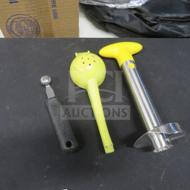 Assorted bar tools set including melon baller, citrus squeezer, and stainless steel corer. Good condition.