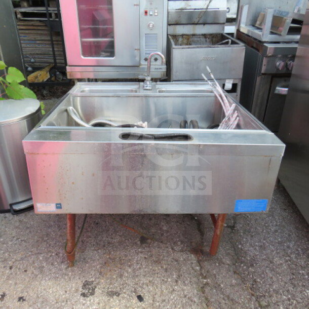 LaCrosse Ice Well with dual sink, faucet, and 2 Wunderbars with guns. Stainless steel, used condition, outdoor setting.