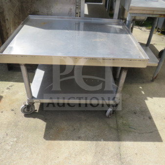 Advance Tabco stainless steel equipment table, 36x30x25 inches, features under shelf, casters; industrial-grade, used.