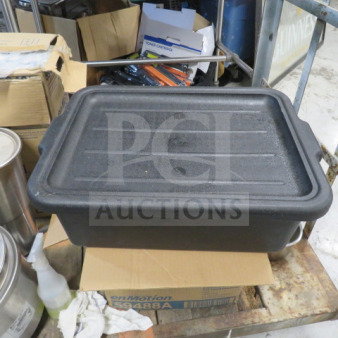 Black bussing tub with lid, durable plastic, used condition. Suitable for storage or transport in kitchen or retail settings.