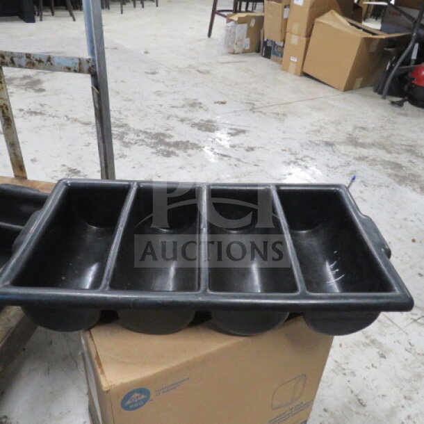 Black four-compartment flatware holder, used condition, durable plastic, suitable for organizing utensils.