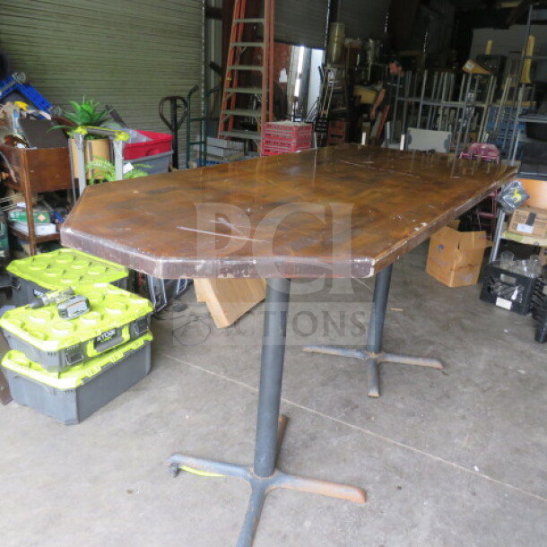 Bar height wooden table, dimensions 84x36x43 inches, with two metal pedestal bases; used condition.