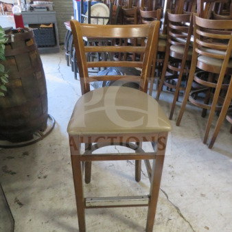 Wooden bar height chair with brown cushioned seat, ladder-back design, in good condition. Model: 4XBID.