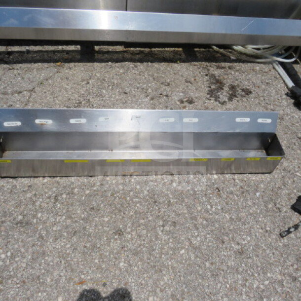 36-inch stainless steel speed rail, sturdy condition, ideal for bar organization, visible mounting holes on back panel.