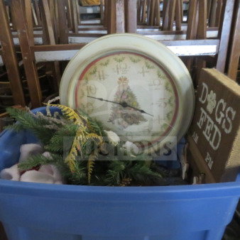 Mixed decor lot in blue bin, includes Christmas-themed clock, greenery, and "Dogs Fed" sign. Items appear gently used.