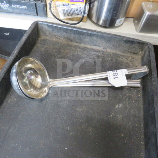 12oz stainless steel ladle in good condition with long handle, visible tag displaying "185" in a black tray.