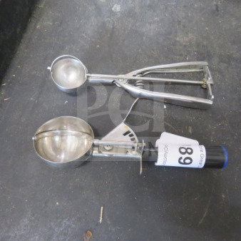 Two assorted dishers, metal construction, different sizes. One has a visible tag marked "89". Used condition.