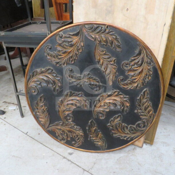 Round wooden decor with intricate carved leaf patterns, dark finish, minor wear, approximately 2 ft diameter, wall hanging.
