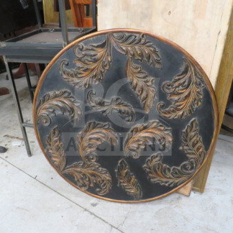 Round wooden decor with intricate carved leaf patterns, dark finish, minor wear, approximately 2 ft diameter, wall hanging.