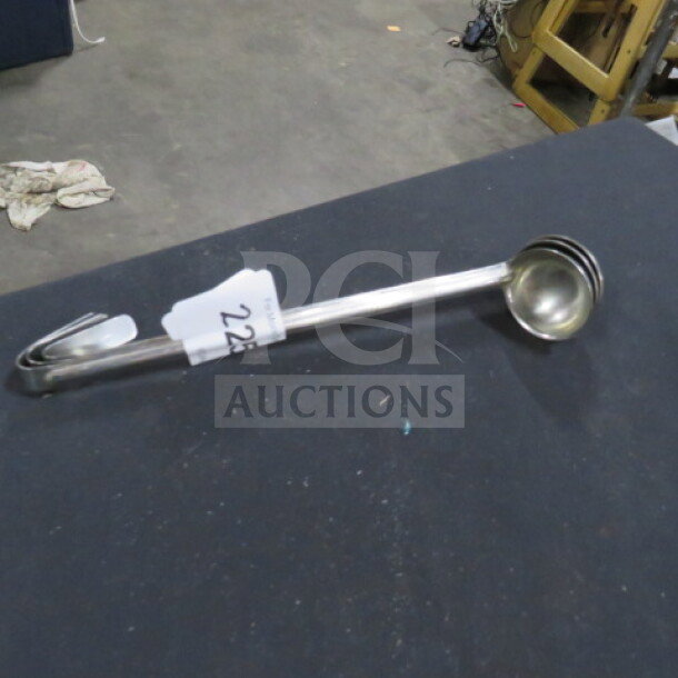 1oz stainless steel ladle with hook and marked label "228." In good condition, ideal for precise serving needs.
