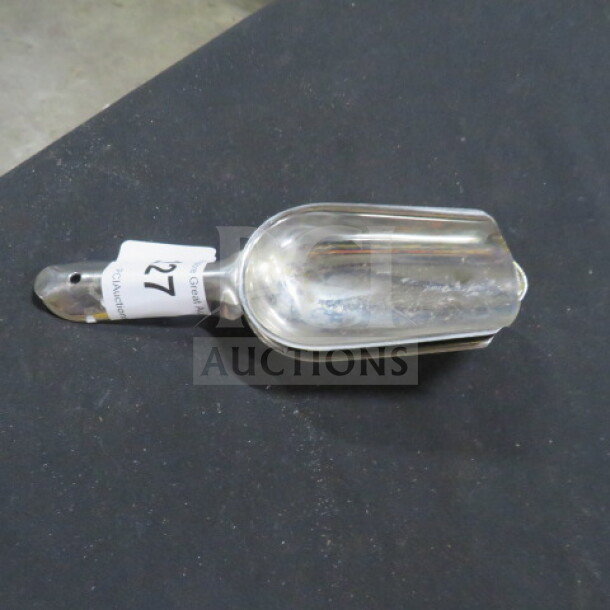 Stainless steel scoop, model 2XBID, in good condition. Features a sturdy handle with visible auction tag reading "127."