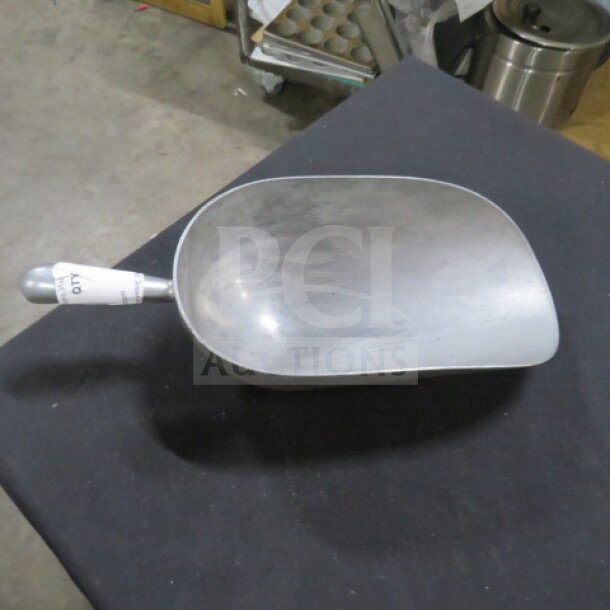Aluminum ice scoop with a rounded bowl and sturdy handle. Slight surface wear, labeled with "Qty" on handle.