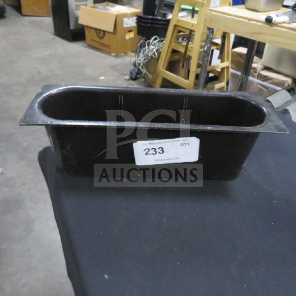 Black rectangular bottle holder with wide rim, showing slight wear. Label reads: "233". Suitable for auctions.