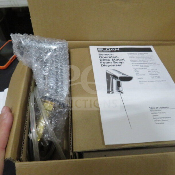 New Sloan Optima Plus Sensor Activated Soap Dispenser, Model ESD400A, in packaging with manual. Price: $703.43.