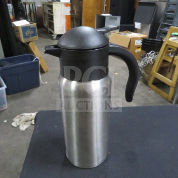 Stainless steel creamer #SJ10 with black lid and handle, in good condition. Ideal for serving cream.