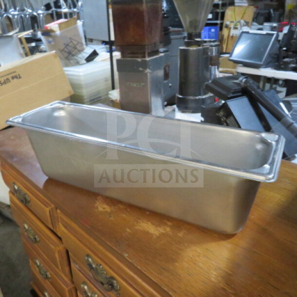 Half size long 6-inch deep stainless steel hotel pan in good condition, ideal for catering and kitchen use.