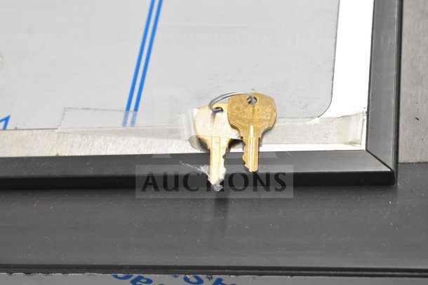 Close-up of the Perlick BC60RT-3 bottle cooler with keys taped to the top, showing detail and condition of the surface.