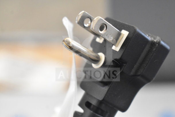 Close-up of a power plug for the 2025 Perlick BC60RT-3 commercial bottle cooler, showing a standard three-prong design.