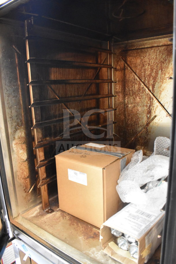 2024 Blodgett Invoq Hybrid 10-2/1GN combi oven interior with racks. Slight rust and visible packaging inside.