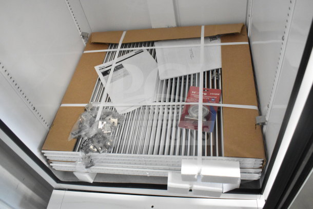 Brand new True TSCI-600R-G-PH single door cooler with components, manual, and thermometer. Condition: Scratch and dent.